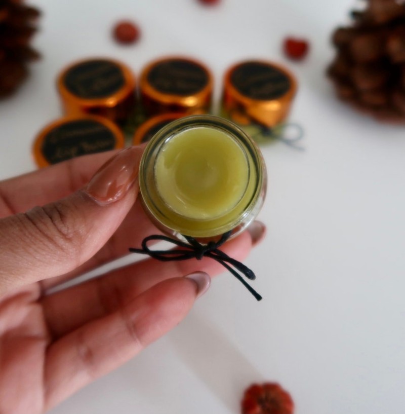 Woman holding a tub of lip balm